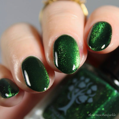 New Divide by Danglefoot Nail Polish, green shimmer jelly magnetic on a light skin tone hand