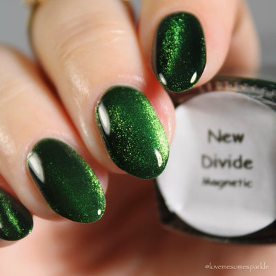 New Divide by Danglefoot Nail Polish, green shimmer jelly magnetic on a light skin tone hand