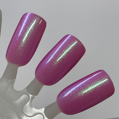 Pig by Dam Nail Polish, warm magenta-pink jelly base with vivid green-to-blue-violet multichrome shimmer shift, swatch stick