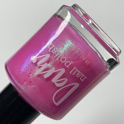 Pig by Dam Nail Polish, magenta-pink base showing blue-violet and teal-green duochrome shimmer flare, bottle standalone product shot