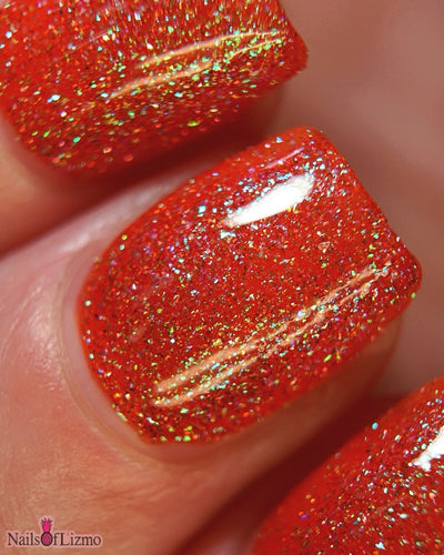 Protector of the Deep by Danglefoot Nail Polish, macro close-up of orange-pink reflective shimmer glitter
