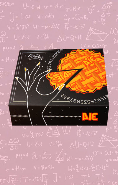 Pi Day Gift Set (Limited Edition) by Starrily, pi-themed gift box showing pie and pi visual pun artwork with stiletto nail illustration, in lifestyle setting