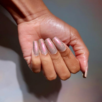 Speed Force by Danglefoot Nail Polish, black-grey holographic duochrome shimmer flakie on a medium-deep skin tone hand