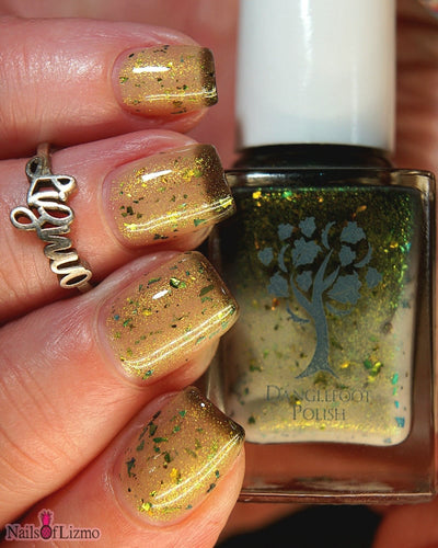 Succumb to the Fear by Danglefoot Nail Polish, black-gold multichrome shimmer flakie thermal on a light skin tone hand