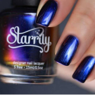 Dark Music (Multichrome) by Starrily, deep navy to indigo-violet multichrome with metallic shimmer, bottle held in a light-medium hand