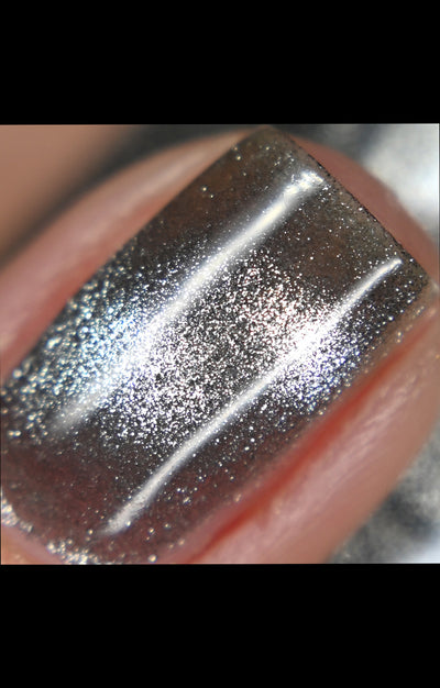 Amulet by Starrily, macro close-up of dense silver foil magnetic effect with warm taupe undertone, 3D depth, and strong specular highlights against shadowed pull zones
