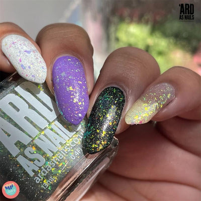 Saturn by 'Ard As Nails, gold-green multichrome holo flakie topper showing green-gold on dark bases and gold-to-pink-to-purple on light base, layering demo