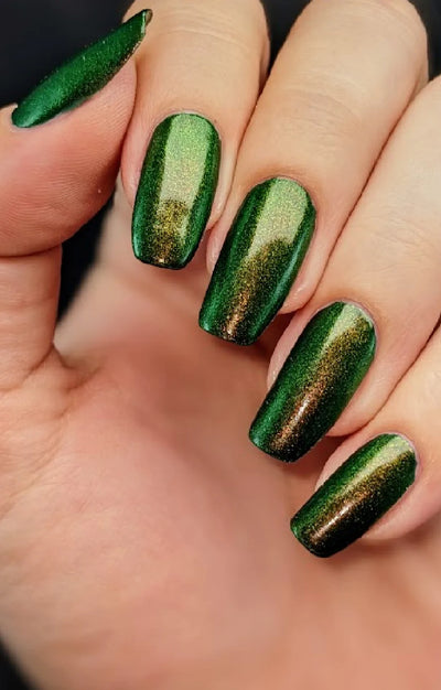 Artemis by Starrily, forest green shimmer showing copper-to-lime-green shift with bright green highlight across the nail, on a light skin tone hand