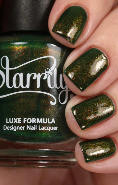 Artemis by Starrily, deep forest green with intense copper-to-green color-shifting shimmer under studio light, bottle held in a light hand