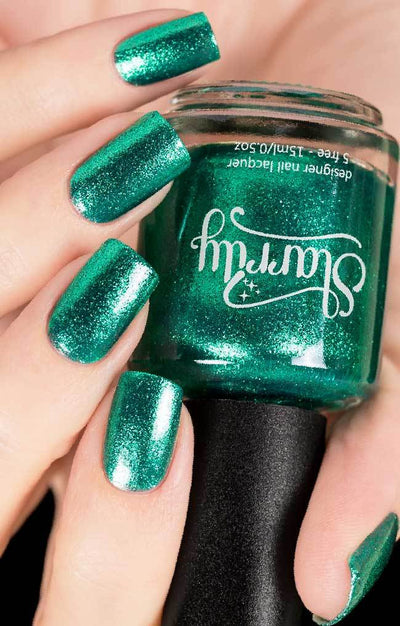 Bellatrix (Green Foil) by Starrily, bright minty green metallic flakie with pale mint reflective highlights, bottle held in a light hand
