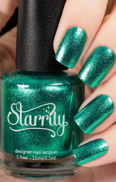 Bellatrix (Green Foil) by Starrily, emerald green metallic flakie with foil-like reflective shimmer, bottle held in a light hand