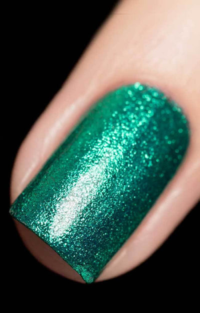 Bellatrix (Green Foil) by Starrily, minty emerald metallic flakie showing high-density emerald-to-mint sparkle under direct flash, on a light skin tone hand