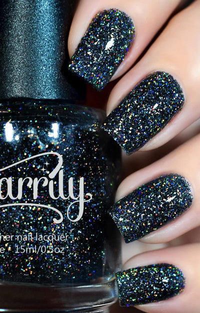 Black Diamond by Starrily, deep black holographic glitter with dense rainbow micro-glitter scatter, on a light skin tone hand