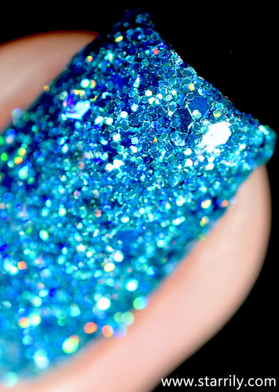 Blitzen by Starrily, macro close-up of mixed cyan and cobalt blue hexagonal glitter particles in a teal-blue jelly base with holographic flash