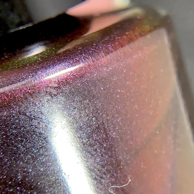 Change of Heart by Dam Nail Polish, macro close-up of blackened red base with dense red-to-burnt-orange multichrome microflakes and holographic sparkle