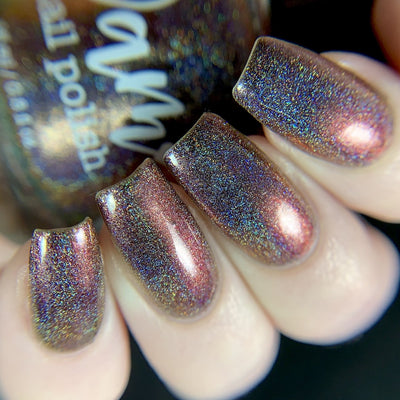 Change of Heart (Holo) by Dam Nail Polish, deep red holographic multichrome with linear holo scatter and red-to-copper-orange shift, on a light skin tone hand