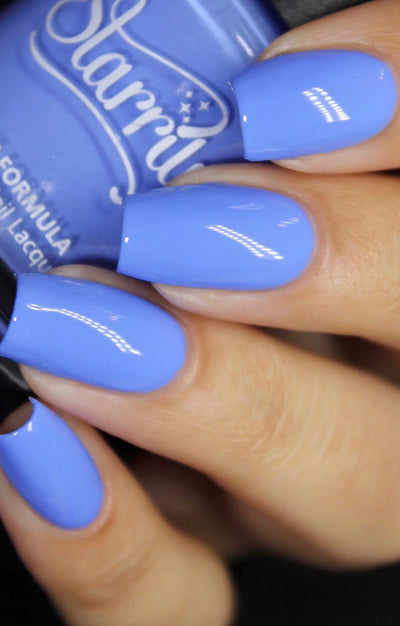 Cloudscape by Starrily, periwinkle blue creme with soft lavender undertone, on a light-medium skin tone hand