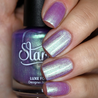Fairy Fountain by Starrily, light purple base with silver-green multichrome shimmer shift, bottle held in a light hand
