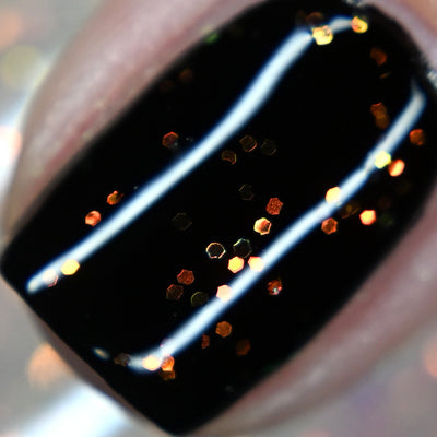 Firefly Jar (Limited Edition) by Starrily, clear flakie topper with scattered hexagonal flakes shifting orange to gold with green, macro close-up of the gold-dominant flake angle over a deep black base