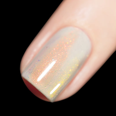 Daisy by Starrily, sheer white-grey base with intense orange shimmer and golden holographic flecks under direct flash, on a light skin tone hand