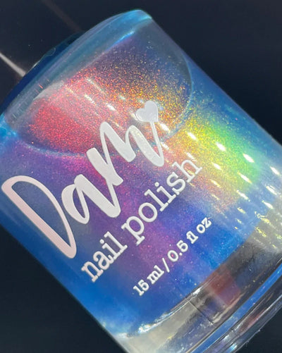 GTFO My Uterus by Dam Nail Polish, vivid cerulean blue multichrome shimmer showing red, gold, and green shift, bottle standalone product shot