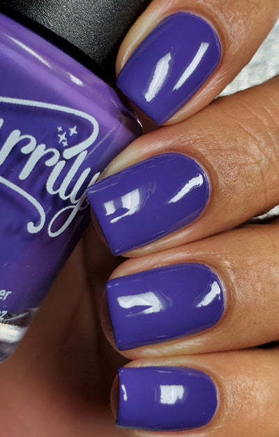 Gravity by Starrily, rich blue-violet purple creme with high-gloss finish, on a medium-deep skin tone hand