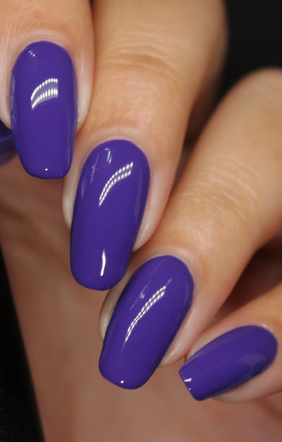Gravity by Starrily, opaque medium violet-purple creme with bright topcoat shine, on a light-medium skin tone hand