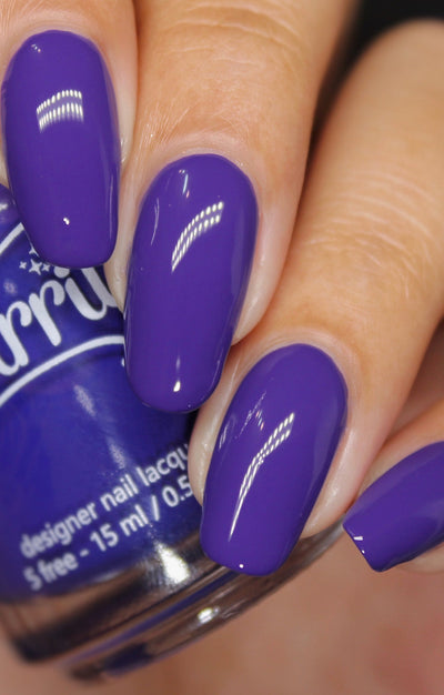 Gravity by Starrily, opaque medium-toned violet-purple creme showing deeper shadow tones, on a light skin tone hand