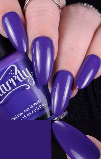Gravity by Starrily, rich opaque medium violet-purple creme on long almond-shaped nails, on a light skin tone hand