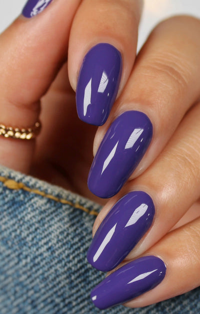Gravity by Starrily, medium-deep violet-purple creme with rich shadowed depth, on a light-medium skin tone hand