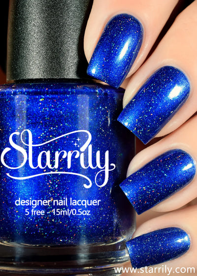 Heart of the Ocean by Starrily, vivid sapphire blue holographic with linear rainbow holo scatter in studio light, bottle held in a light skin tone hand