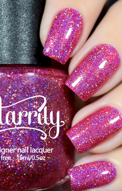 High Maintenance by Starrily, hot pink holographic glitter with violet holo flash and multidimensional disco-ball sparkle, bottle held in a light skin tone hand