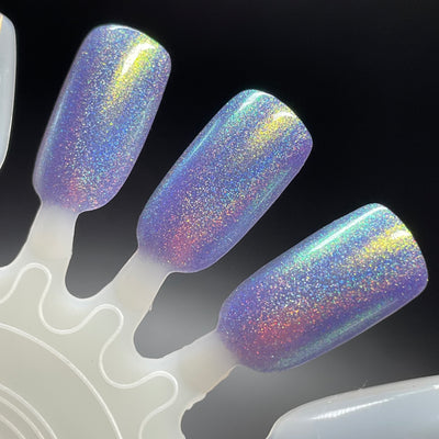 Data Is My Love Language by Dam Nail Polish, blue-leaning lavender linear holographic with high-intensity rainbow scatter and gold-green shimmer shift, swatch stick