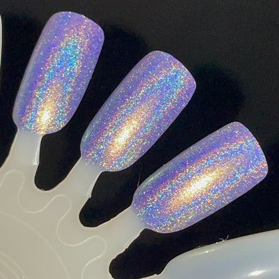 Data Is My Love Language by Dam Nail Polish, blue-leaning lavender linear holographic with dense gold-to-green shifting shimmer under flash, swatch stick