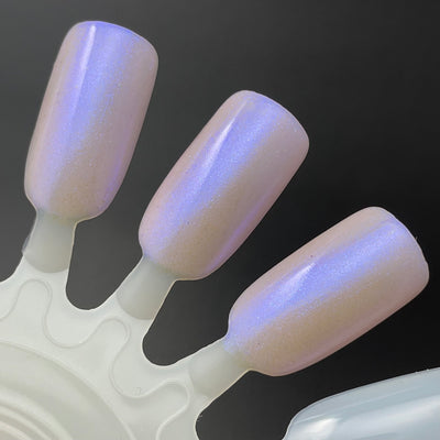 A Whimsical Dream by Dam Nail Polish, sheer warm pink base with strong blue-purple duochrome shimmer and fine pearlescent particles, swatch wheel