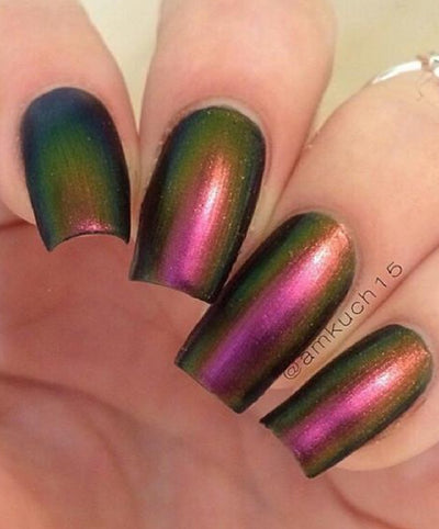 Love Affair by Starrily, gold-green multichrome mid-shift from olive green to magenta-pink with copper highlights, on a light skin tone hand