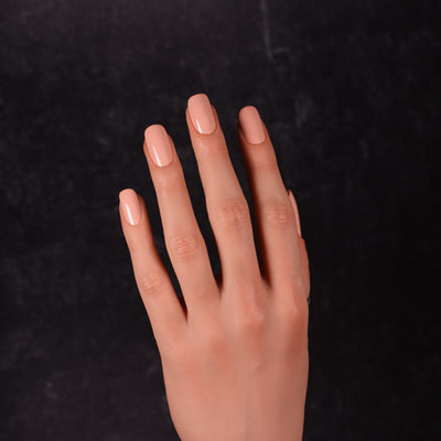 Maned Wolf by Dimension Nails, soft peachy-salmon creme with warm smoky undertone, on a light-medium skin tone hand