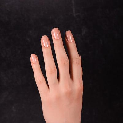 Maned Wolf by Dimension Nails, muted dusty rose-peach creme with subtle smoky undertone, on a light skin tone hand