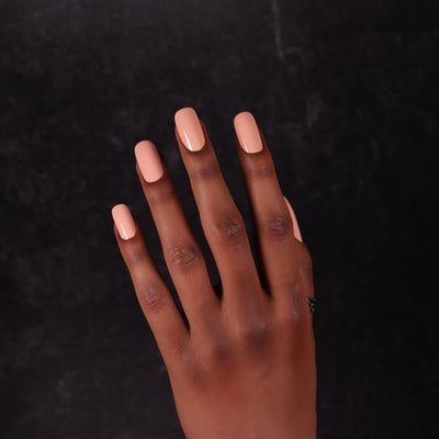 Maned Wolf by Dimension Nails, light peachy-coral pastel orange creme, glossy finish, on a rich skin tone hand