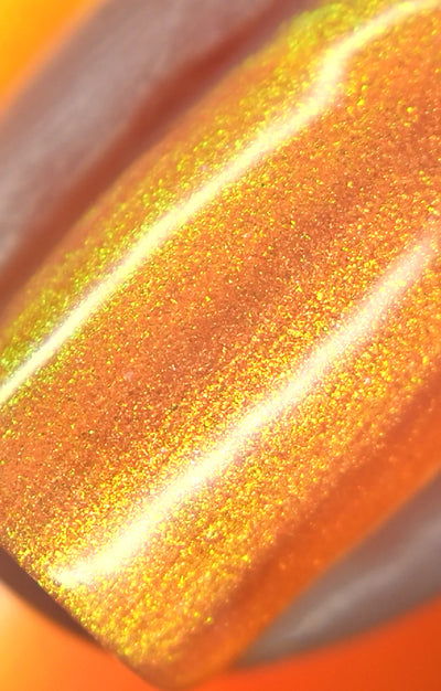 Peach Glow by Starrily, macro close-up of dense gold-to-yellow-green duochrome shimmer over a burnt orange base under direct flash