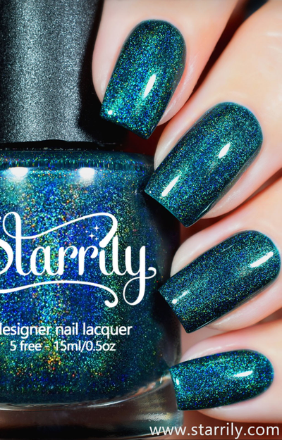 Quantum Energy by Starrily, emerald-peacock green linear holographic with teal-to-blue-to-green color shift, bottle held in a light skin tone hand