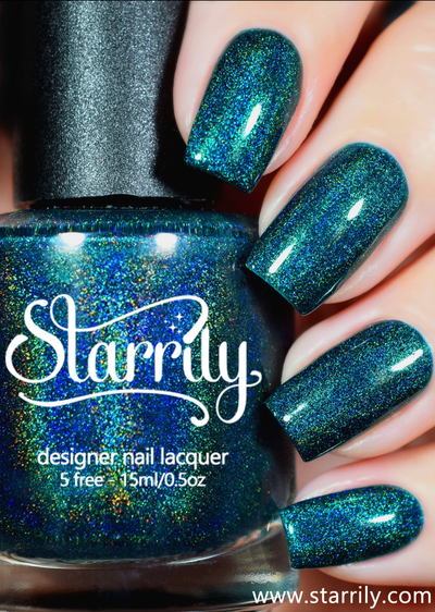 Quantum Energy by Starrily, deep teal-green linear holographic with shifting cobalt blue and strong rainbow holo sparkle, bottle held in a light skin tone hand