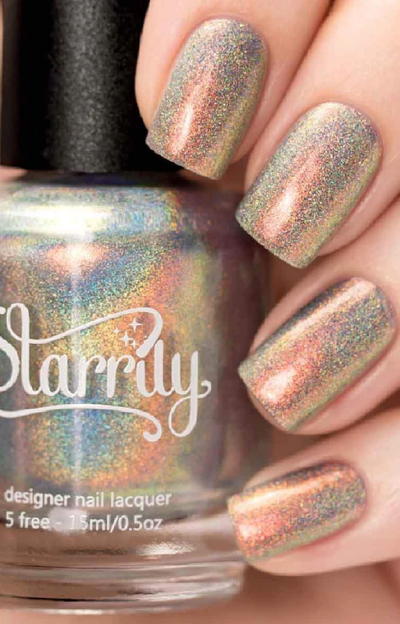 Moon Beam by Starrily, holographic shimmer shifting from coppery orange to sage green with linear holo scatter, bottle held in a light hand