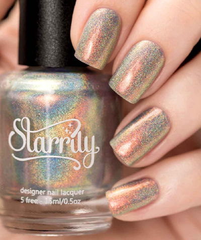 Moon Beam by Starrily, warm rose-taupe holographic shimmer shifting to olive green with dense rainbow scatter, bottle held in a light hand