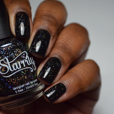 Neutrino by Starrily, jet black base with scattered silver holographic glitter showing orange and gold rainbow flash, bottle held in a deep skin tone hand
