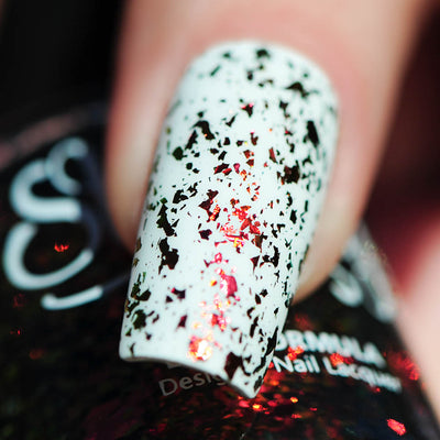 Crunchy Leaves by Starrily, gold-green multichrome flakie topper with red-orange-to-green shifting shards over pale mint-white base, macro close-up of large irregular flakie contrast