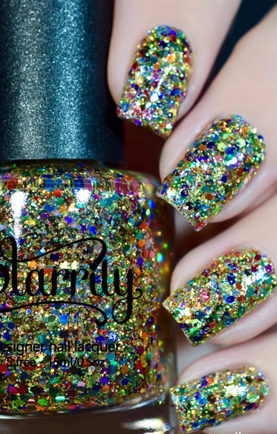 Christmas Lights by Starrily, clear-base glitter topper with multi-sized gold, green, pink, and rainbow holographic hex glitters, bottle held in a light skin tone hand