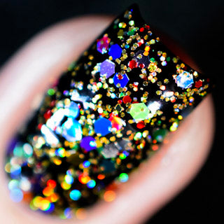 Christmas Lights by Starrily, macro close-up of gold and silver holographic hex glitters over a dark base, revealing full-spectrum rainbow sparkle under direct flash