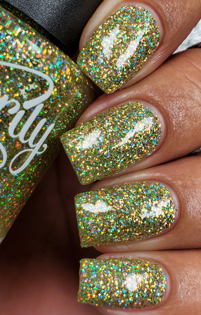 Limelight by Starrily, lime green holographic glitter in clear base with dense rainbow spectral scatter under flash, on a medium skin tone hand
