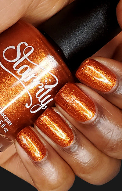 Sunlight (Orange Foil) by Starrily, copper-orange metallic foil with bright micro-flakie shimmer, bottle held in a light-medium hand